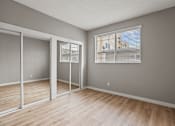 Thumbnail 20 of 62 - Bedroom with Double Mirrored Closets, Vinyl Flooring, and Window