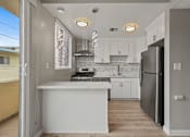 Thumbnail 8 of 62 - Open-Concept Kitchen with Countertop Bar