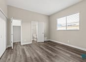 Thumbnail 33 of 62 - Bedroom with Bathroom, Large Windows, Closet, and Vinyl Flooring