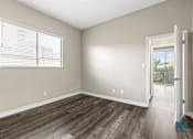 Thumbnail 31 of 62 - Bedroom with Large Windows and Vinyl Flooring
