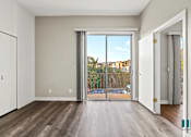 Thumbnail 48 of 62 - Bedroom with Closet, Balcony with Double Glass Doors, and Vinyl Flooring
