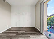 Thumbnail 41 of 62 - Bedroom with Double-Closets, Vinyl Flooring, and Balcony