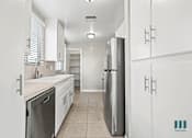 Thumbnail 50 of 62 - Kitchen with Stainless-Steel Appliances, Cabinet Storage, and Pantry