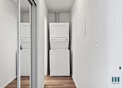 Thumbnail 10 of 23 - A white wall with a fridge and a washing machine.