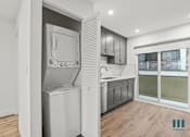 Thumbnail 21 of 23 - A modern kitchen with a dishwasher and a refrigerator.