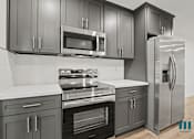 Thumbnail 14 of 23 - A kitchen with a stove, oven, microwave, and refrigerator.