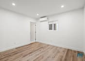 Thumbnail 22 of 23 - A room with wooden flooring and a window with blinds.
