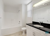 Thumbnail 44 of 65 - Bathroom with Full-Size Bathtub, Vanity Cabinet Storage, and Window