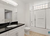 Thumbnail 37 of 65 - Bathroom with Full-Size Bathtub with Glass Door and Vanity Cabinet with Storage
