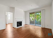 Thumbnail 31 of 65 - Living Room with Vinyl Flooring, Electric Fireplace, and Patio