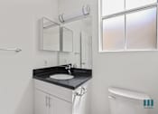 Thumbnail 52 of 65 - Bathroom with Windows and Vanity Cabinet Storage