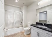 Thumbnail 26 of 38 - Large-Size Bathroom with Bathtub with a Glass Door and Cabinet Storage