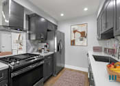 Thumbnail 1 of 36 - Kitchen with Stainless-Steel Appliances and Ample Cabinet Storage