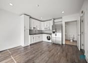 Thumbnail 37 of 48 - A kitchen with white cabinets and stainless steel appliances.