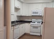 Thumbnail 28 of 48 - Full-Size Kitchen with Ample Cabinet Storage and Vinyl Flooring