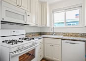 Thumbnail 11 of 65 - Kitchen with Refrigerator, Stove, Dishwasher, and Microwave Oven