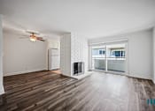 Thumbnail 8 of 65 - Open-Concept Dining and Living Room with Vinyl Flooring, Fireplace, and Patio