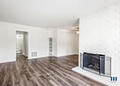 Thumbnail 7 of 65 - Open-Concept Living Room with a Fireplace and Vinyl Flooring