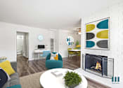 Thumbnail 3 of 65 - A living room with a fireplace and a couch.