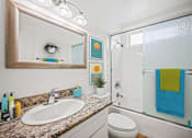 Thumbnail 6 of 65 - Bathroom with Shower Bath with Glass Door and Vanity Cabinet Storage