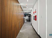 Thumbnail 105 of 106 - Hallway Leading to Mailbox Area at Ogden Garden by Wiseman, California, 90036