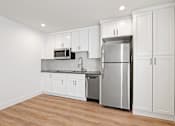 Thumbnail 55 of 65 - Studio Apartment Kitchen including Dishwasher, Full-Size Refrigerator, and Microwave Oven