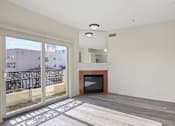 Thumbnail 12 of 48 - Bright Living Room Space with an Electric Fireplace and Private Balcony