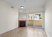 Thumbnail 21 of 48 - Living Room Space with Electric Fireplace and Private Balcony