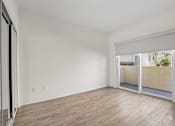 Thumbnail 16 of 48 - Spacious Bedroom with Mirrored Closet and Private Balcony