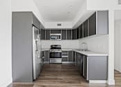 Thumbnail 14 of 71 - Full-Size Kitchen with Stainless-Steel Refrigerator, Stove, Microwave Oven, and Dishwasher