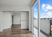 Thumbnail 22 of 71 - Bedroom with Mirrored Closet, Vinyl flooring, and Balcony with Skyline Views
