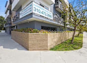 Thumbnail 49 of 49 - A building with a sign that says "Experience Good Living" and a phone number.