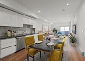 Thumbnail 5 of 49 - A modern kitchen with a dining table set for four.
