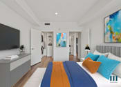 Thumbnail 3 of 49 - A modern bedroom with a large bed and a painting on the wall.