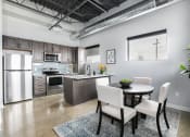 Thumbnail 19 of 31 - an open kitchen and dining room with a table and chairs