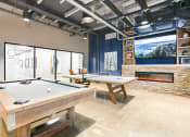 Thumbnail 24 of 31 - a game room with two pool tables and a fireplace