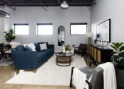 Thumbnail 3 of 31 - a living room with a blue couch and a table