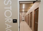 Thumbnail 17 of 31 - a corridor in a building with a door to a prison cell door