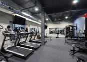 Thumbnail 2 of 31 - a gym filled with cardio equipment and weights