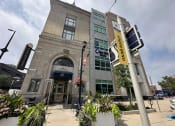 Thumbnail 3 of 17 - a building with a traffic light in front of it