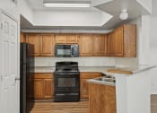 Thumbnail 1 of 15 - Kitchen with cabinets at Cypress View Villa Apartments in Weatherford TX