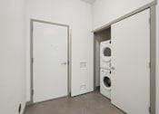 Thumbnail 34 of 43 - A laundry room with a washer and dryer in it.