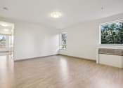 Thumbnail 12 of 43 - A room with wooden floors and white walls.