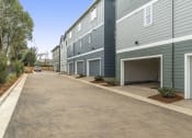 Thumbnail 35 of 42 - an empty parking lot in front of a building with a garage door open