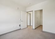 Thumbnail 19 of 43 - A room with a white door and a white wall.