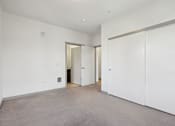 Thumbnail 16 of 43 - A room with white walls and a grey floor.