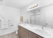 Thumbnail 34 of 42 - a bathroom with two sinks and a mirror
