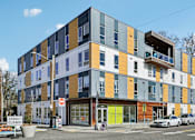 Thumbnail 1 of 43 - A street view of a multi-story building with a