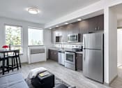 Thumbnail 5 of 43 - A modern kitchen with stainless steel appliances and wooden cabinets.