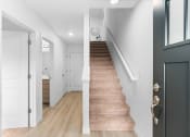 Thumbnail 42 of 42 - a staircase in a home with white walls and wood floors